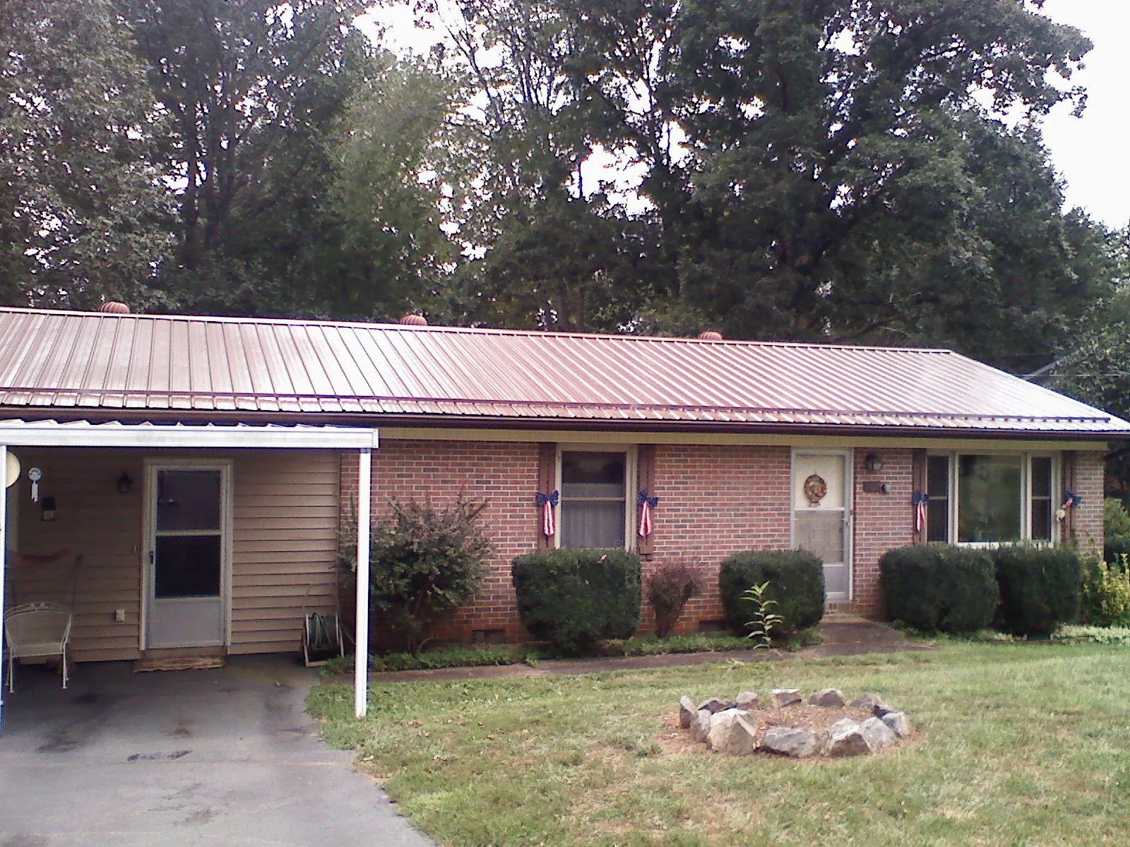 Bronze metal roof and carport on a brick ranch home — Roof Repair work by our crew in Hillside